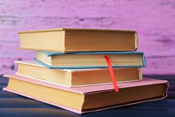 Pile of books on wooden background