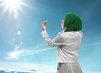 Back view of muslim woman praying