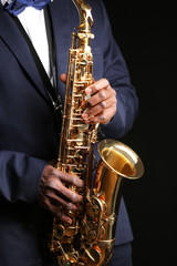 Fototapeta premium African American jazz musician playing the saxophone, closeup