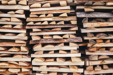 Splinters of logs stacked near the fence