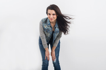 woman posing in jeans on white wall