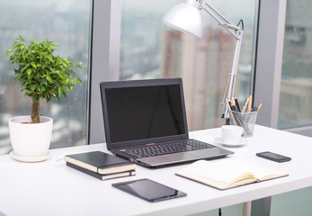 Office workplace with notebook on wood table.