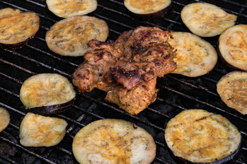 Grilled eggplant and chicken steak on grill grid fire bbq