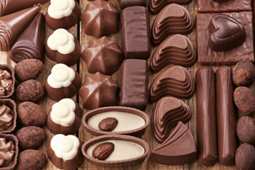 Assortment of delicious chocolate candies background, close up