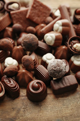 Assortment of delicious chocolate candies background, close up