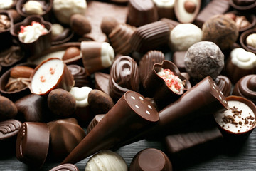 Assortment of delicious chocolate candies background, close up