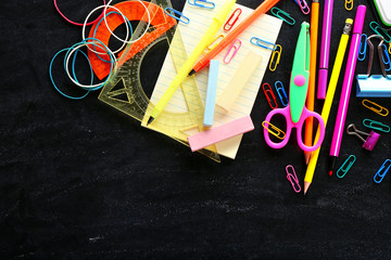 Colourful stationery on black background