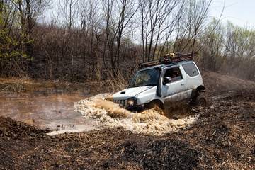 Fototapeta na wymiar Suzuki Jimny crossing water obstacle