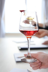 Experts tasting new sorts of wine at the table