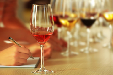 Woman tasting new sorts of wine at the table