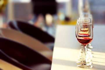 Many glasses of different wine in a row on a table