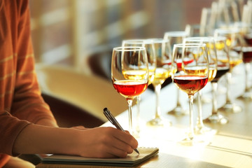 Many glasses of different wine in a row on a table