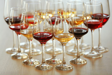 Many glasses of different wine on a table