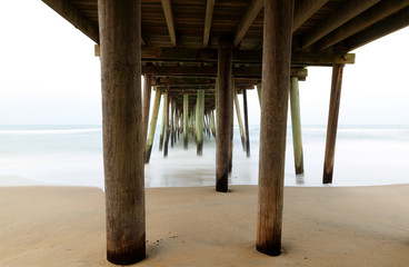 Fishing Pier On A Cloudy Day at Virginia Beach, Virginia, USA. Long Exposure Effects Applied.