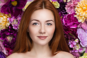 Charming girl with an angelic face and a beautiful accessories flower big pink roses background....