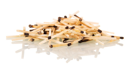 Handful of charred matchsticks isolated on white 
