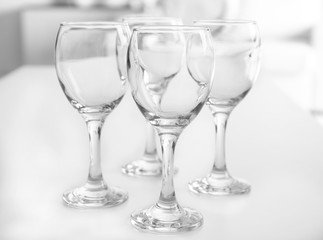 Wineglasses on blurred interior background
