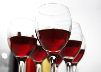 Glasses of red wine on white table closeup