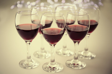Glasses of red wine on white table closeup