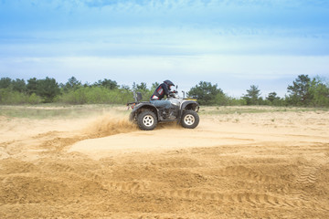 Racing ATV is sand.