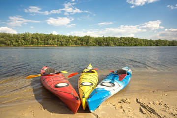 Camping with kayaks on the beach on a sunny day.