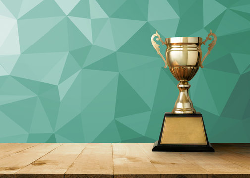 golden trophy on wood table with vintage White Polygonal Mosaic