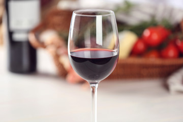 Glass of wine with food on blurred background