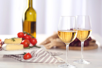 Glasses of red wine with food on table closeup