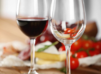 Glasses of wine with food on table closeup