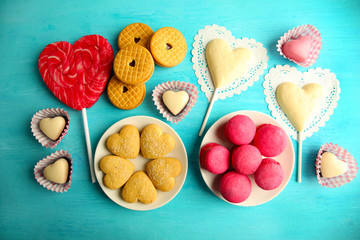 Valentine concept. Composition of cookies and candies on blue background