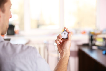 Man holds stopwatch in hand, close up