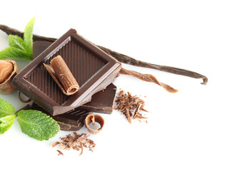 Chocolate with mint and hazelnuts on white background