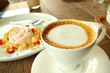 Obraz na płótnie Canvas Coffee and white cake in cafe shop