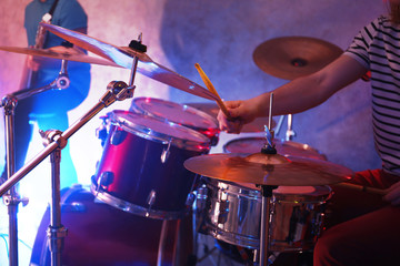 Fototapeta na wymiar Drummer playing on drum set on stage.