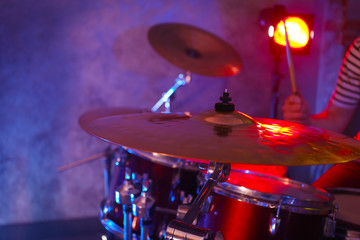 Naklejka na ściany i meble Drummer playing on drum set on stage.