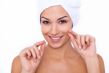 She knows the importance of flossing. Portrait of an attractive young woman using dental floss and...