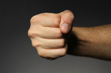 Male fist on grey background