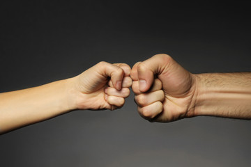 Man and woman fists on grey background