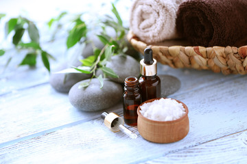 Spa composition with green leaves on wooden background