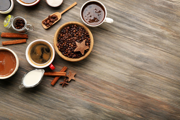 Assorted fresh coffee with spices on wooden table, top view