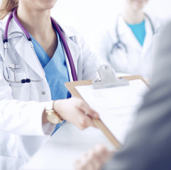 Medical team sitting at the table in modern hospital