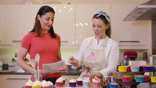  TV presenters on a cookery channel making cupcakes & talking to camera