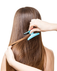 The girl with long brown hair make hair. Isolated on white .