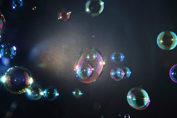 Rainbow soap bubbles on a dark backgrounds