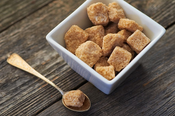 brown cane sugar on old wooden background