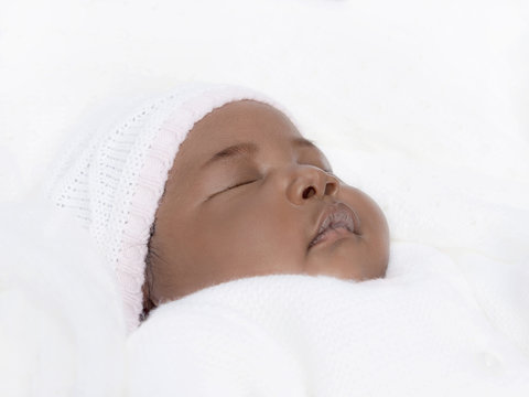 Portrait of a one-month-old baby girl sleeping 