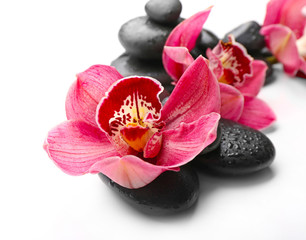 Spa stones and red orchid isolated on white