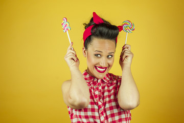 Close up portrait beautiful pin up girl with colorful lollipops