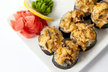 Baked sushi rolls on the white plate