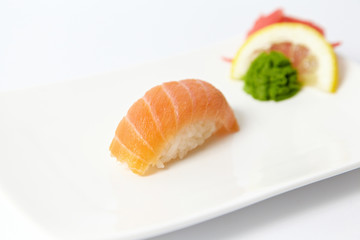 Salmon sushi with lemon, ginger and wasabi 